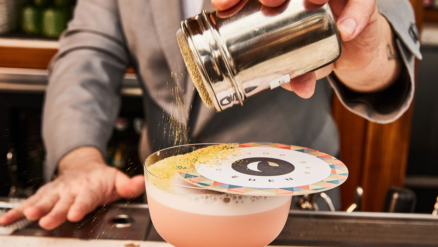 Bartender garnishing a cocktail