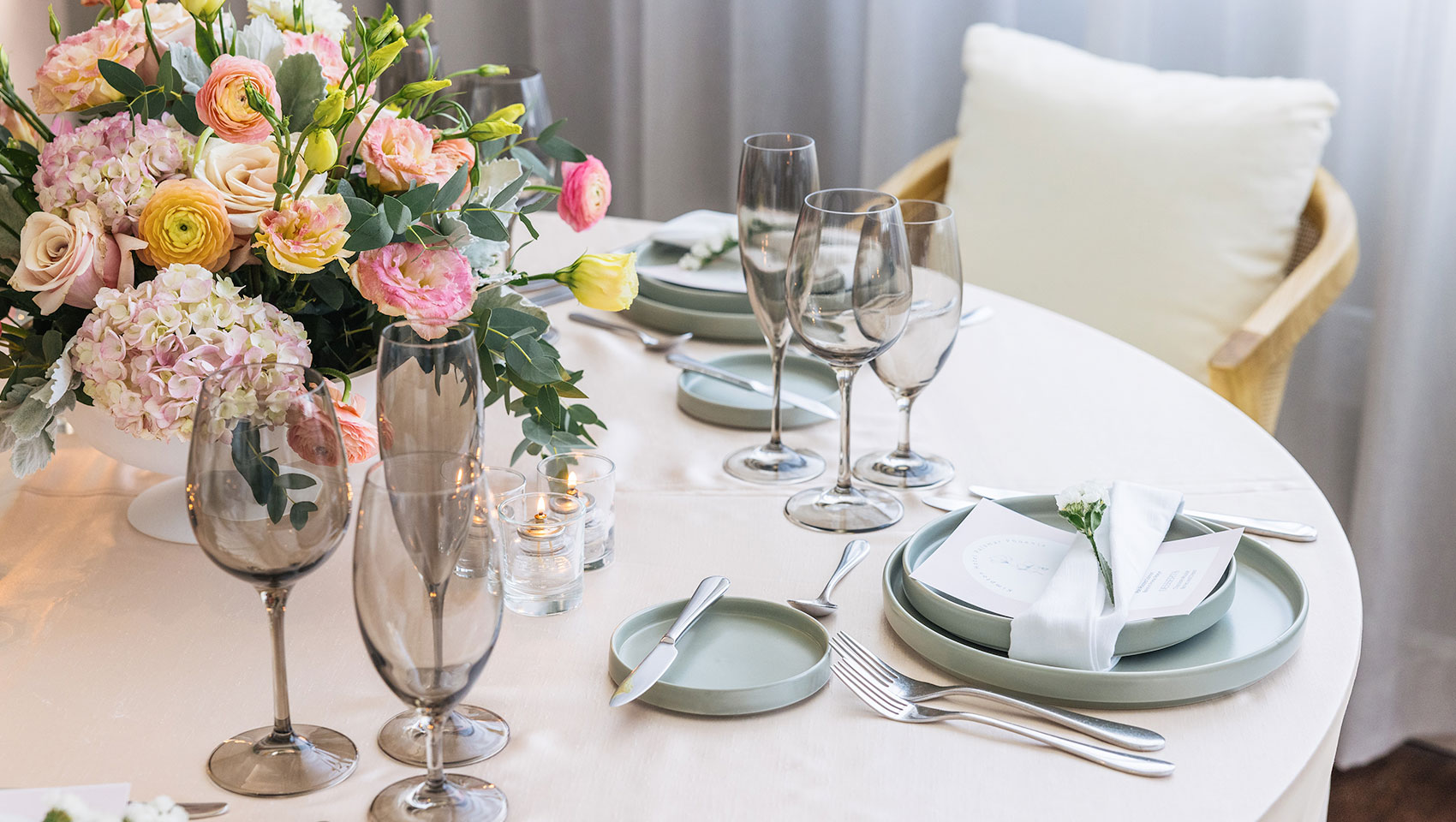 Fresco Room Table Set with flowers, glasses and light blueish gray plates