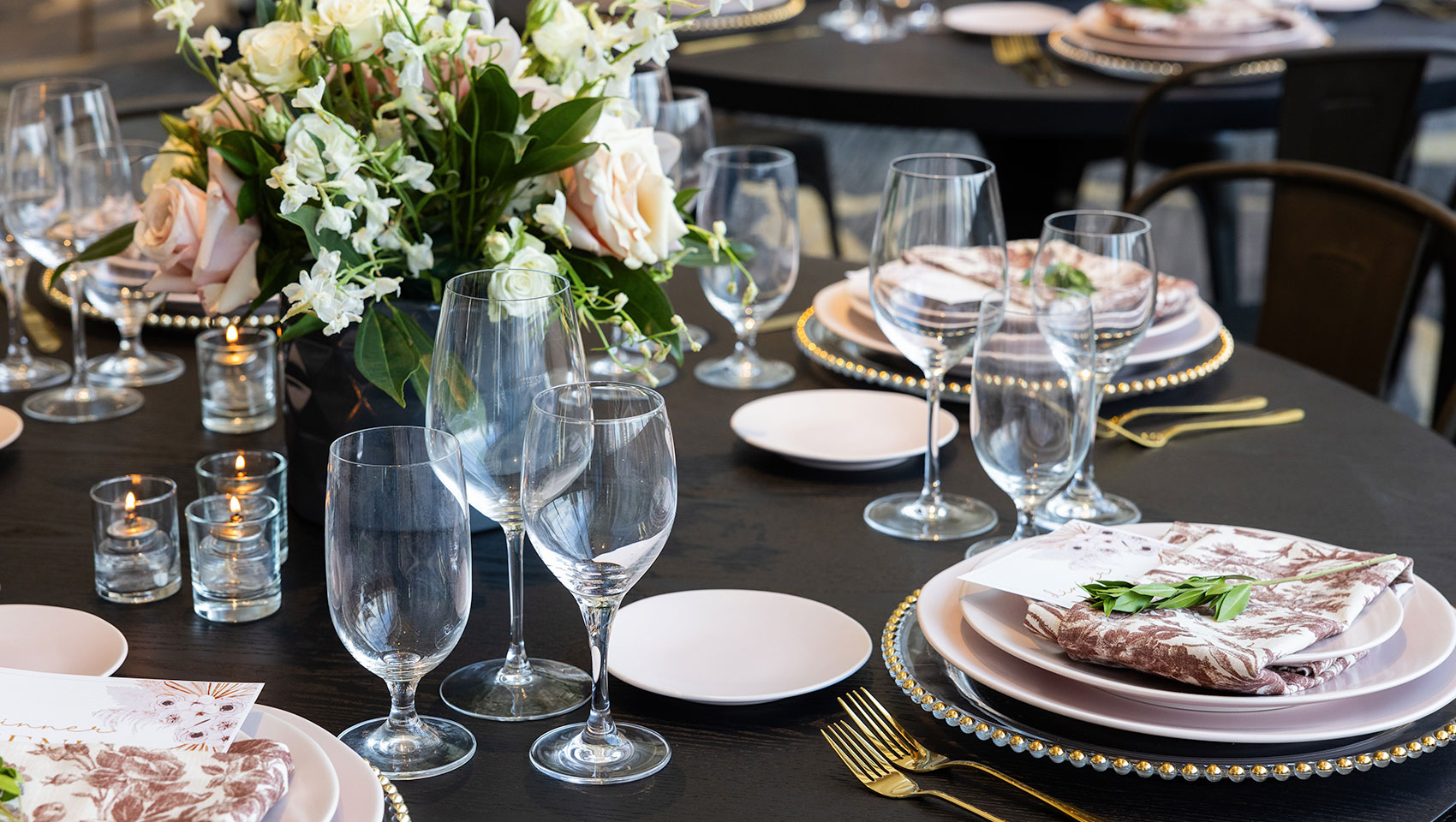 Table with dinnerware set up + candles and flowers in Zia Room