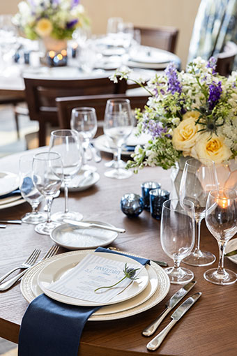 Wedding Reception table set up with flowers and blue cloth napkins