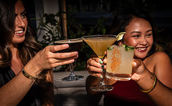 women cheers with cocktails at eden rooftop bar